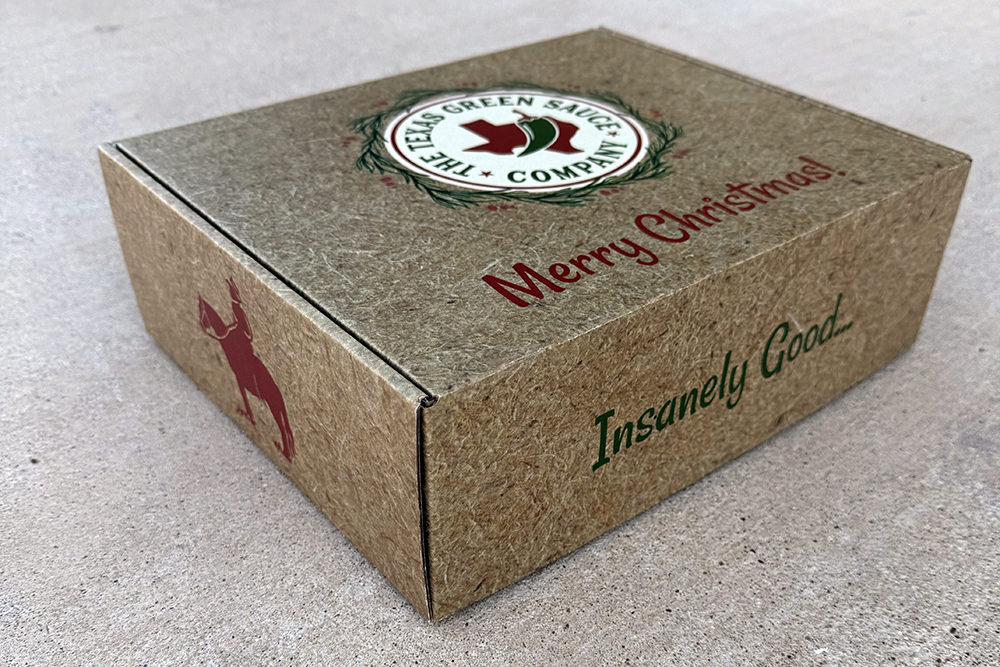 Texas Green Sauce Holiday Gift Box exterior with Merry Christmas branding and Insanely Good tagline - festive kraft packaging